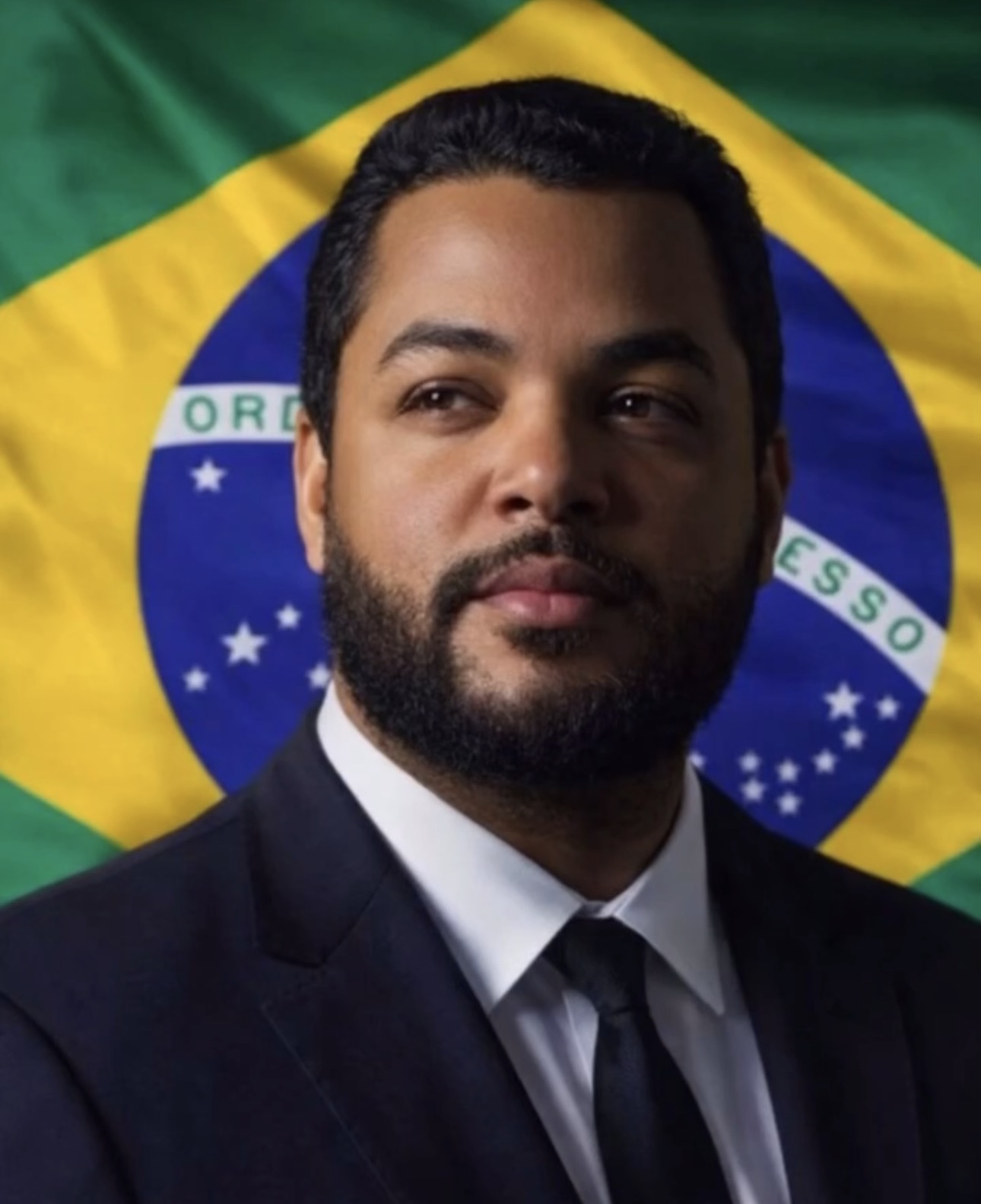 Retrato de Lucas Brás diante da bandeira do Brasil